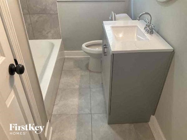 a bathroom with a sink and a toilet and a bath tub
