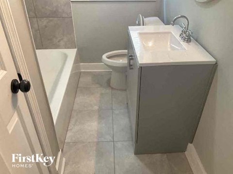 a bathroom with a sink and a toilet and a bath tub