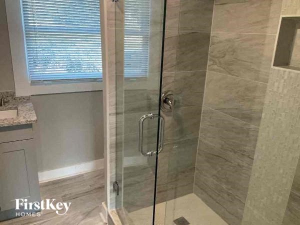 a bathroom with a shower with a glass door