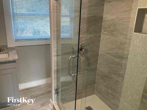 a bathroom with a shower with a glass door