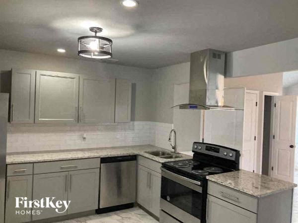 a kitchen with stainless steel appliances and white cabinets