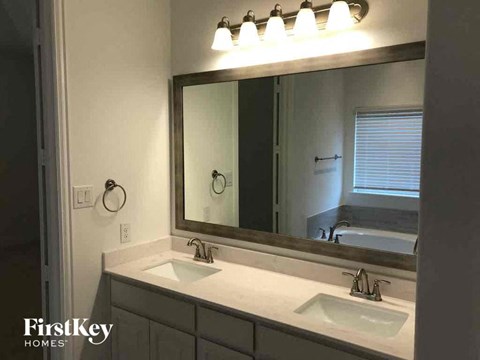 A bathroom with a mirror and two sinks.