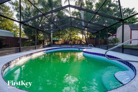 A swimming pool with a FirstKey Homes logo on the side.
