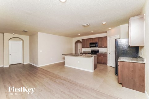 A kitchen area with a countertop and a refrigerator.