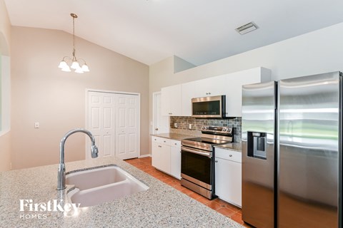 a kitchen with stainless steel appliances and granite counter tops