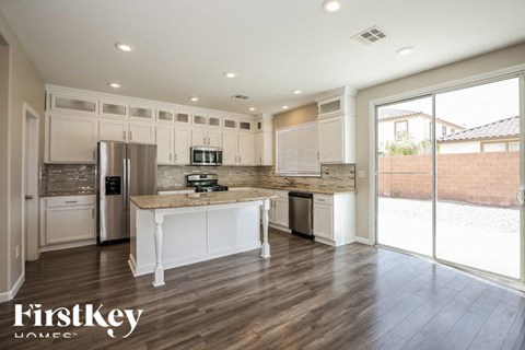 A modern kitchen with wooden floors and a large island.