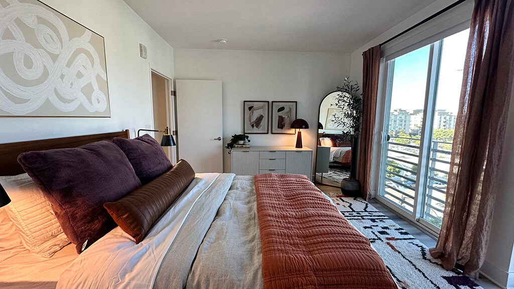 a bedroom with a large bed and a large window at Idea1 Apartments in San Diego CA