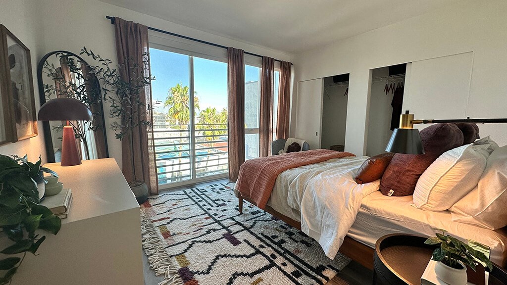 a bedroom with a bed and a sliding glass door at Idea1 Apartments in San Diego CA