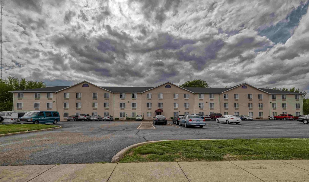 A large building with a parking lot in front of it.