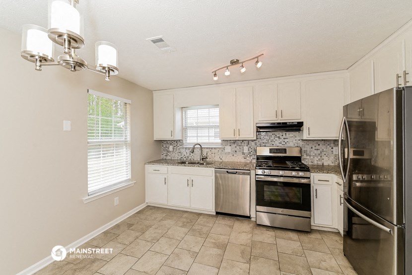 a kitchen with stainless steel appliances and white cabinets