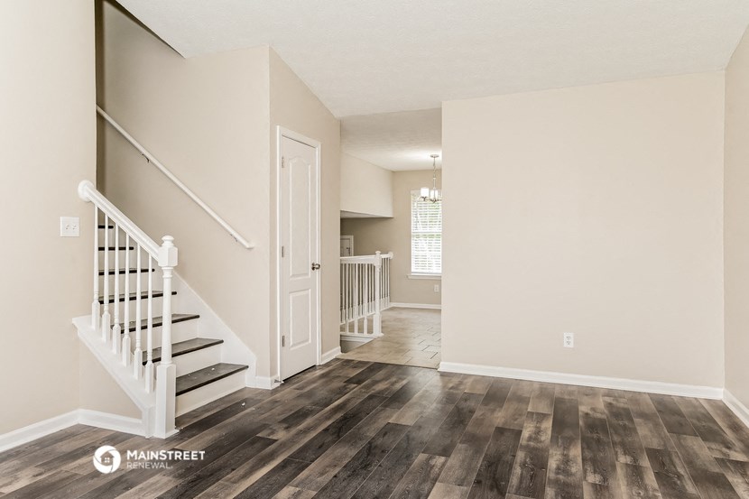 the living room and entryway of a renovated house