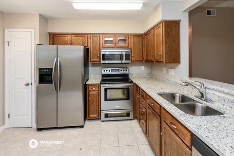 a kitchen with granite counter tops and stainless steel appliances