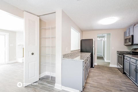 a kitchen with an island and a refrigerator and a sink