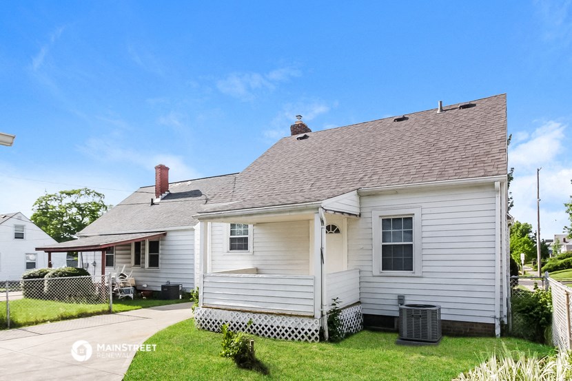 an old with a gray roof on a green lawn