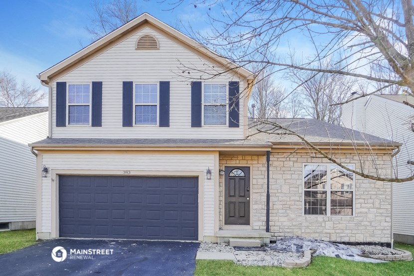 a white house with a black garage door
