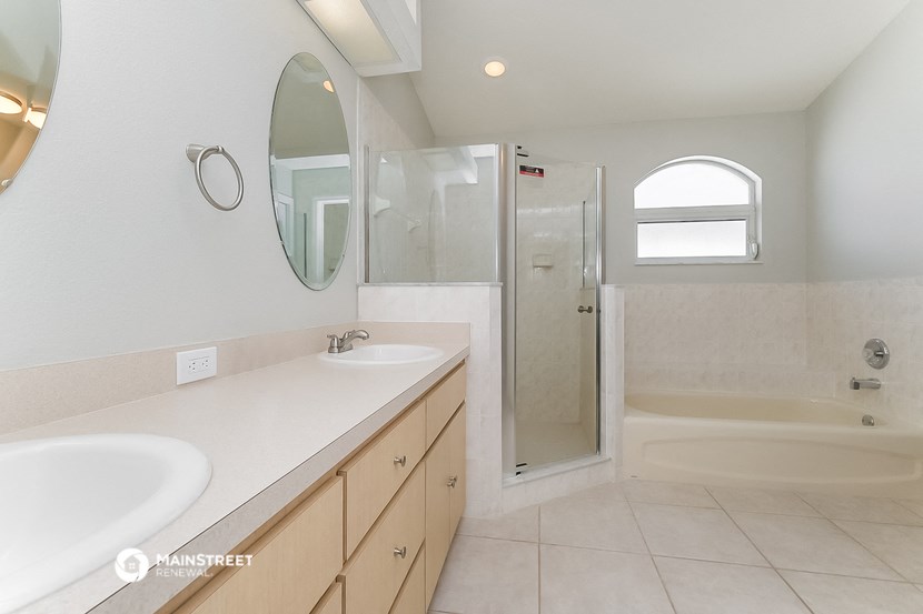 a bathroom with two sinks and a shower