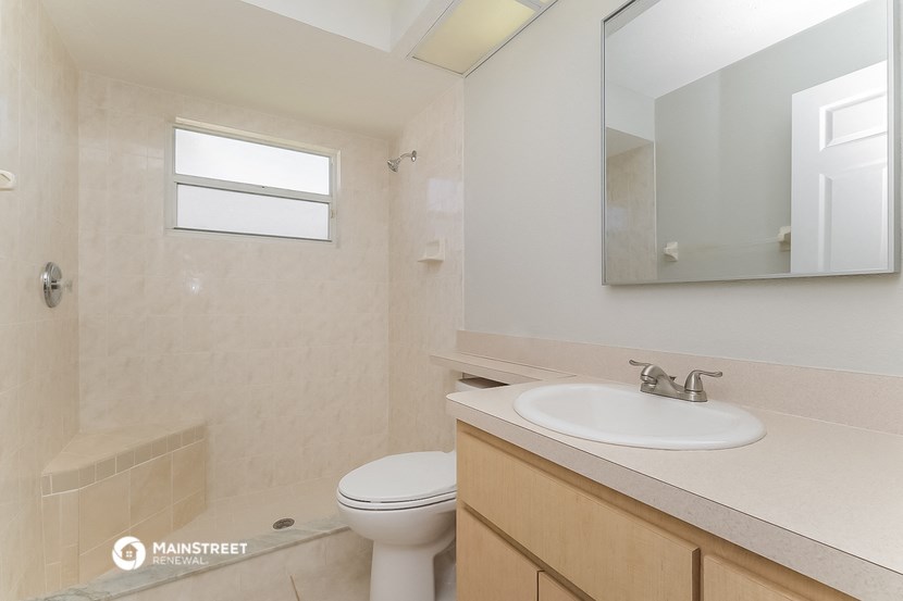a bathroom with a toilet and a sink and a mirror