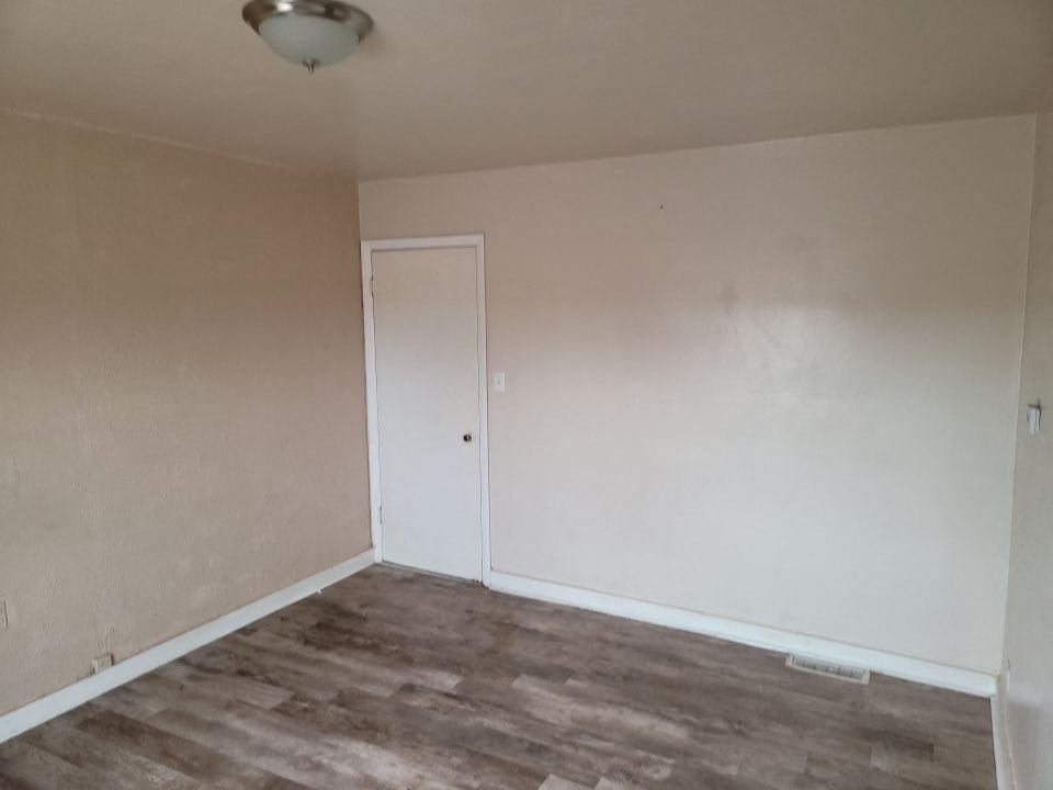 an empty room with white walls and a white door