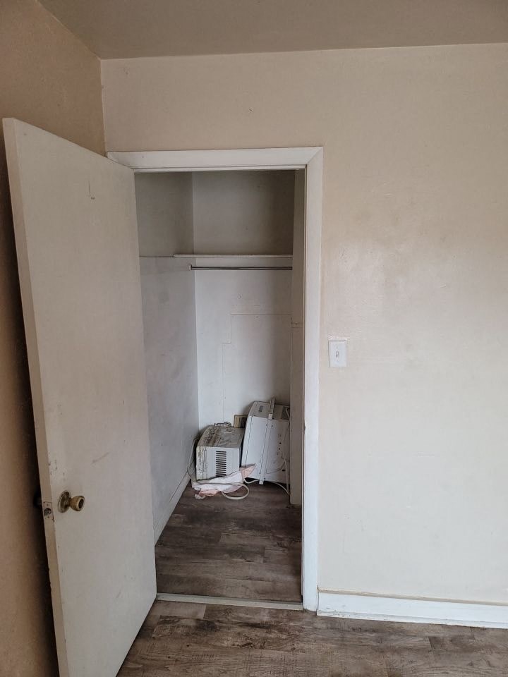 a small room with a white wall and a door