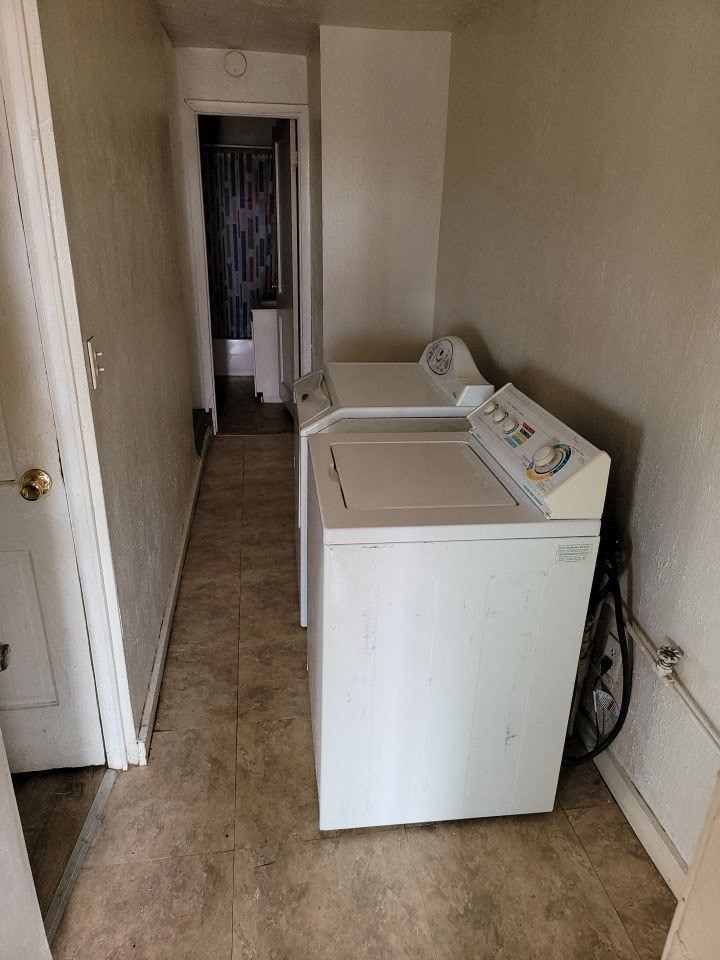 a white washer and dryer in a small room