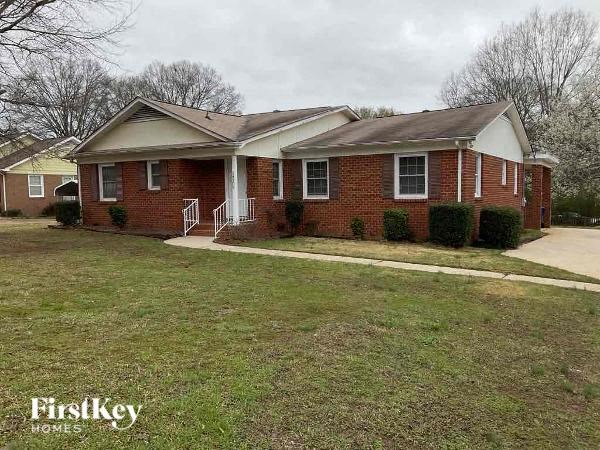 A brick house with a white door and a small porch.