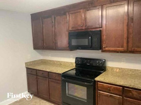 a kitchen with a stove and a microwave