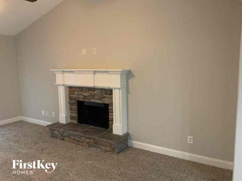 a living room with a stone fireplace