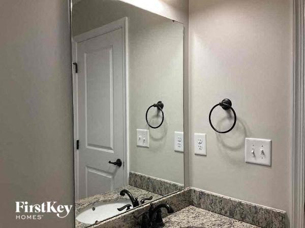 a bathroom with a sink and a large mirror