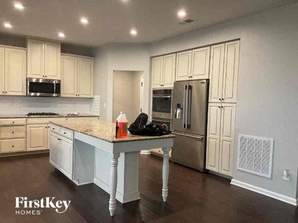 a kitchen with white cabinets and a counter top