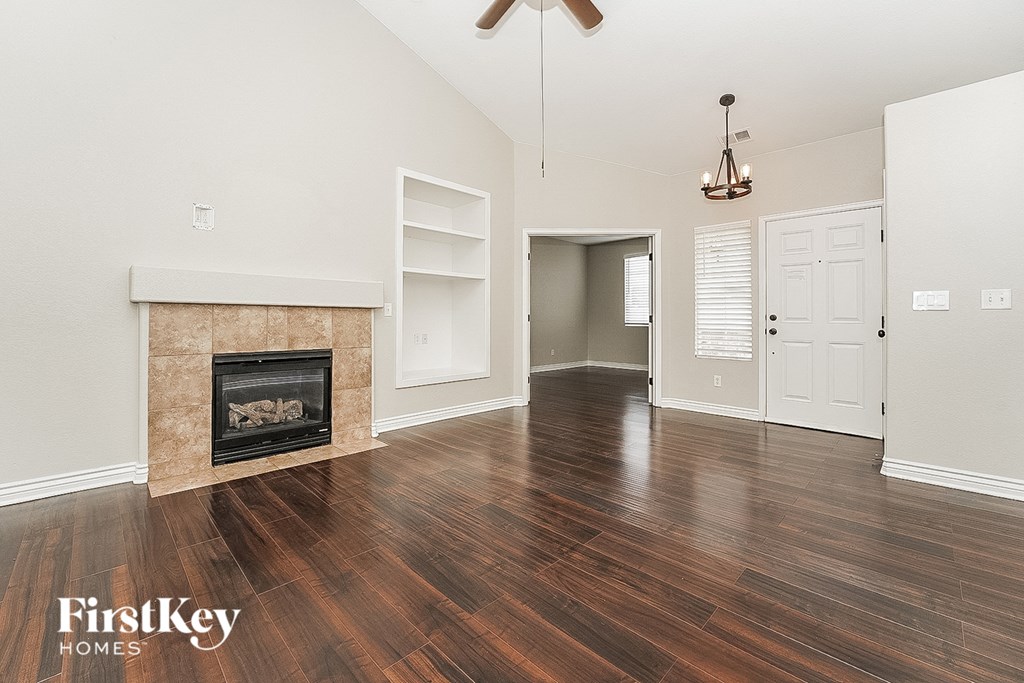 a living room with a fireplace and wooden floors