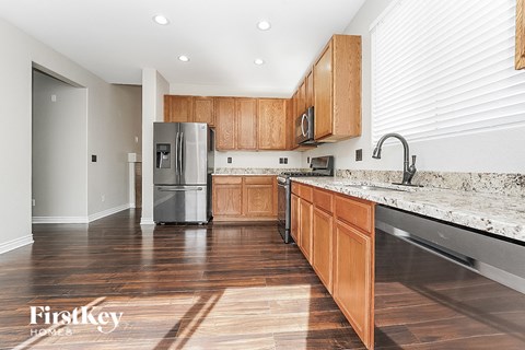 a kitchen with wooden cabinets and a stainless steel refrigerator