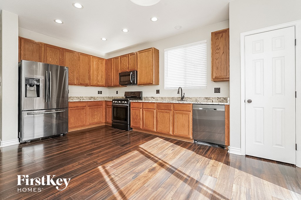 a kitchen with wooden cabinets and stainless steel appliances