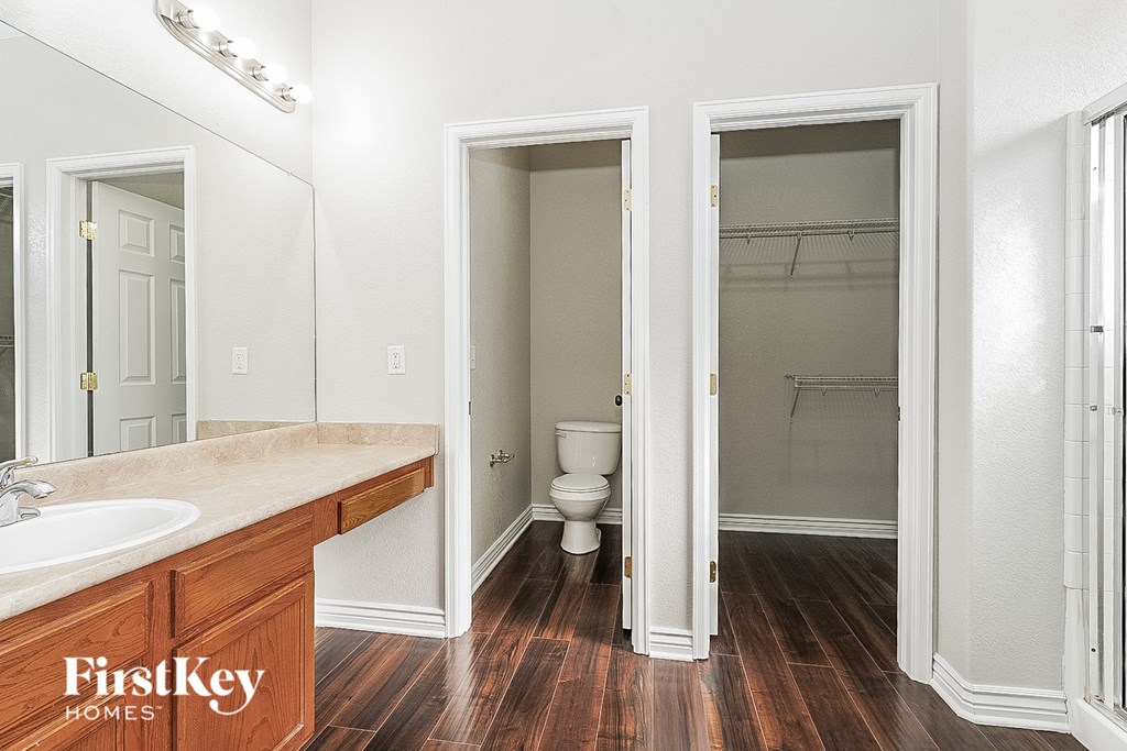 a bathroom with a toilet and a sink and a mirror