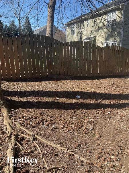 a wooden fence in front of a house