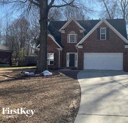 a house with a tree and a white garage door