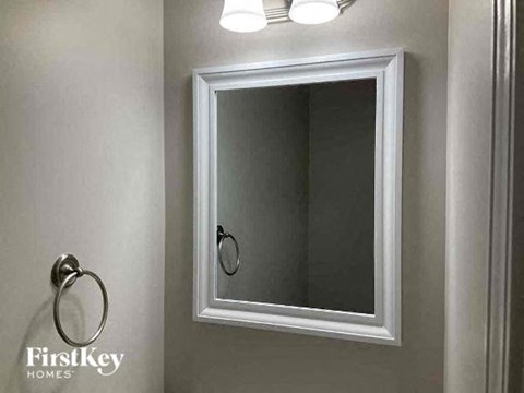 a bathroom with a white mirror and a sink