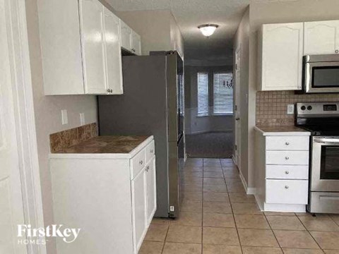 a kitchen with a stove and a refrigerator