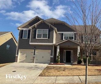 a house with two garage doors on a driveway