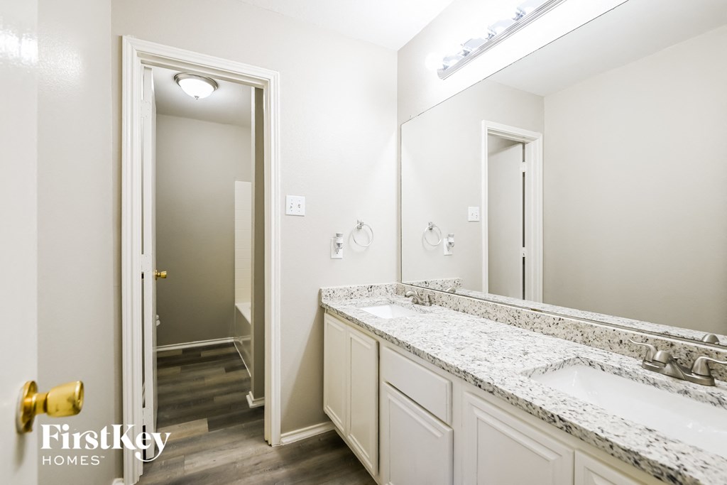 a bathroom with two sinks and a large mirror