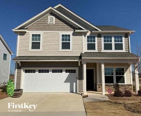 a tan house with a white garage door