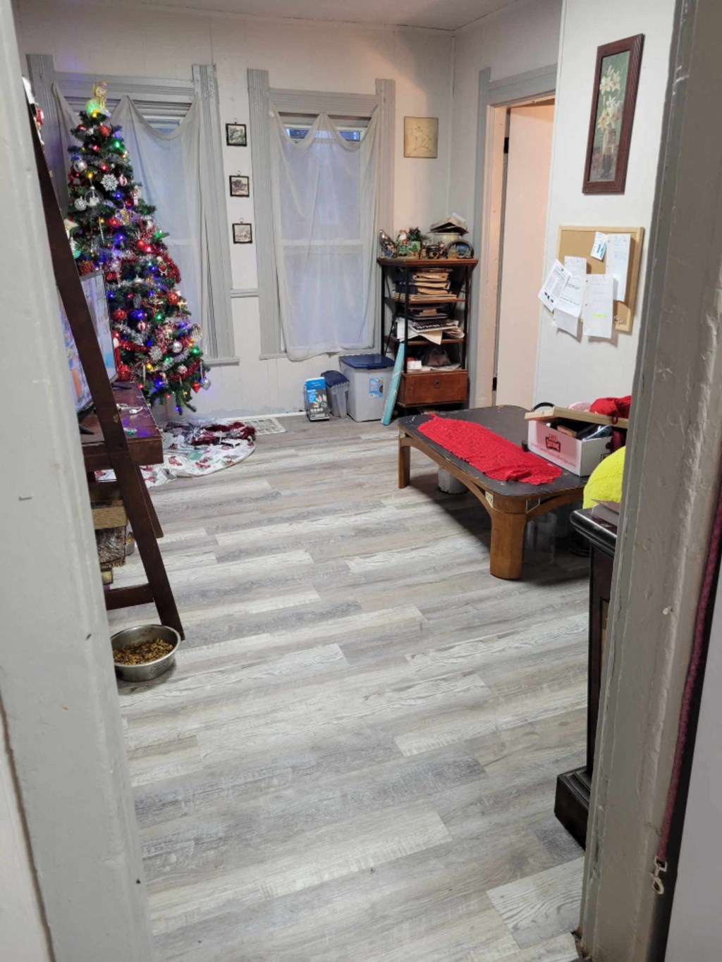 a living room with a christmas tree in the corner