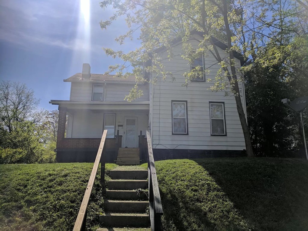 a white house with stairs in front of it