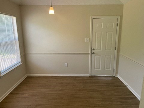 A room with a white door and a window with blinds.