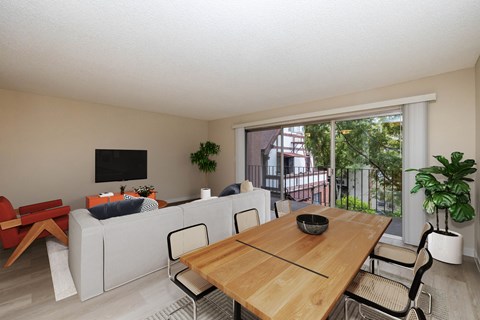 A dining table with chairs and a couch in a room.