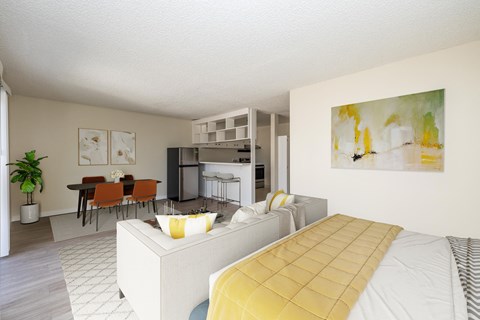 A modern bedroom with a large bed and a dining area in the background.