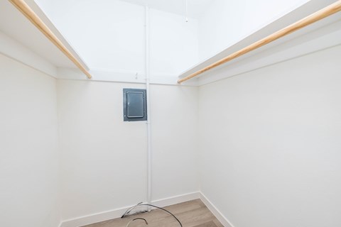 A room with a white wall and a small window.