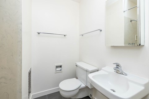 A white toilet and sink in a bathroom.