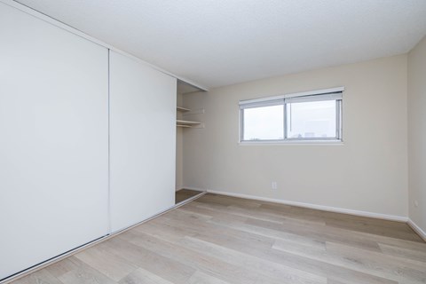 A room with a sliding door and a window.