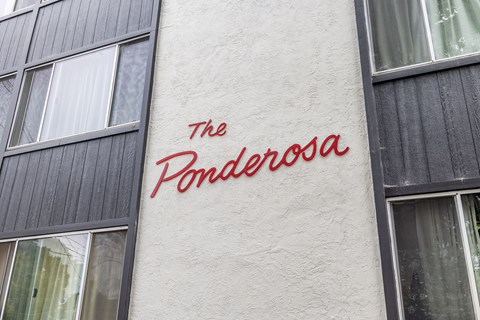 The Penderosa sign is on a white wall.