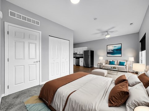 A bedroom with a large bed and a ceiling fan.